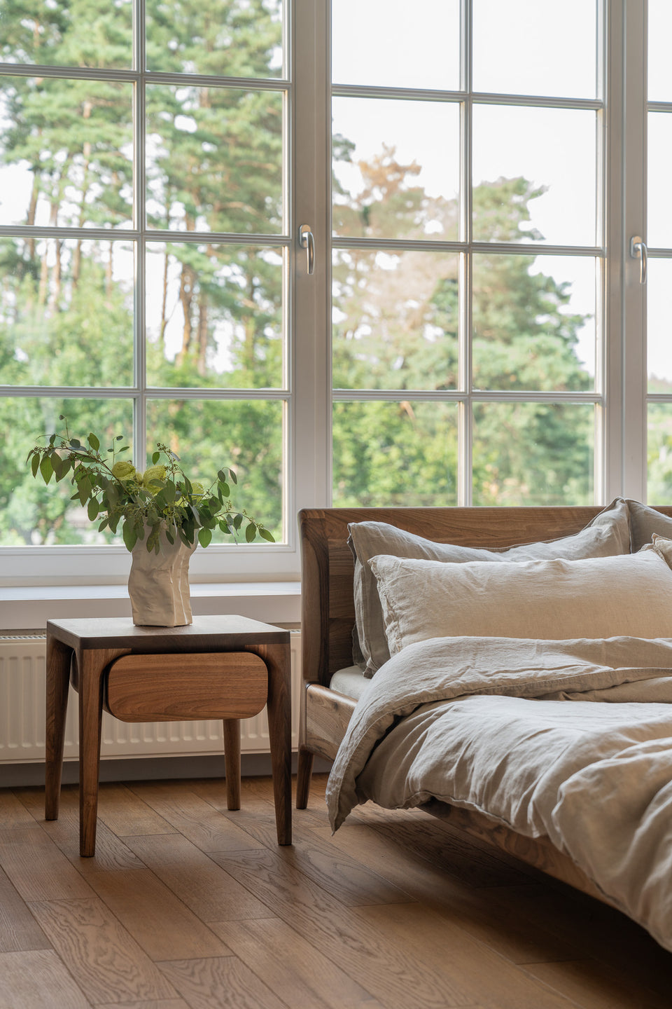 Curved drawer element floating beneath the tabletop.