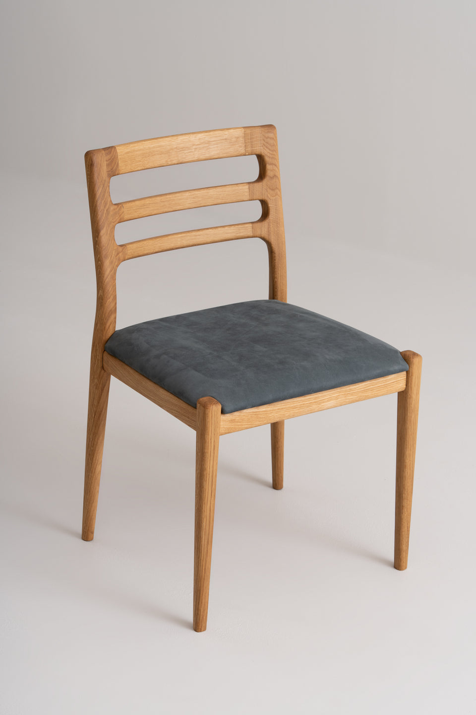 Gently curved backrest with precise Danish-inspired joinery.